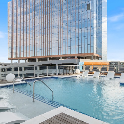 Resort-style swimming pool with lounge seating
